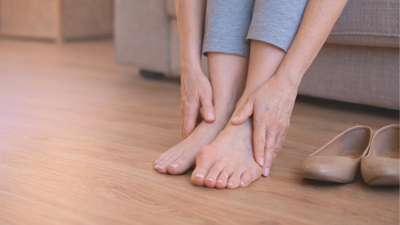Woman holding foot with bunion pain on big toe joint